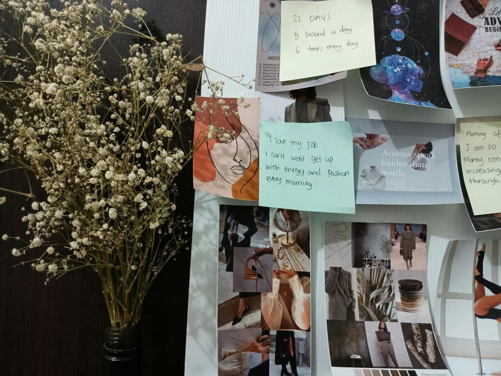 Inspirational mood board featuring floral arrangement and motivational quotes for artistic inspiration.