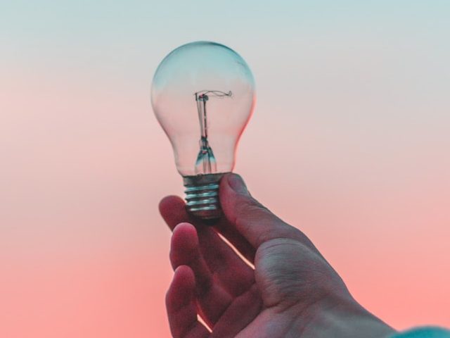 person holding light bulb Photo by Diego PH